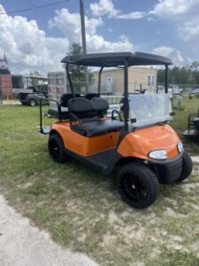 2019 E-Z-GO RXV orange electric golf cart dashboard and seating view