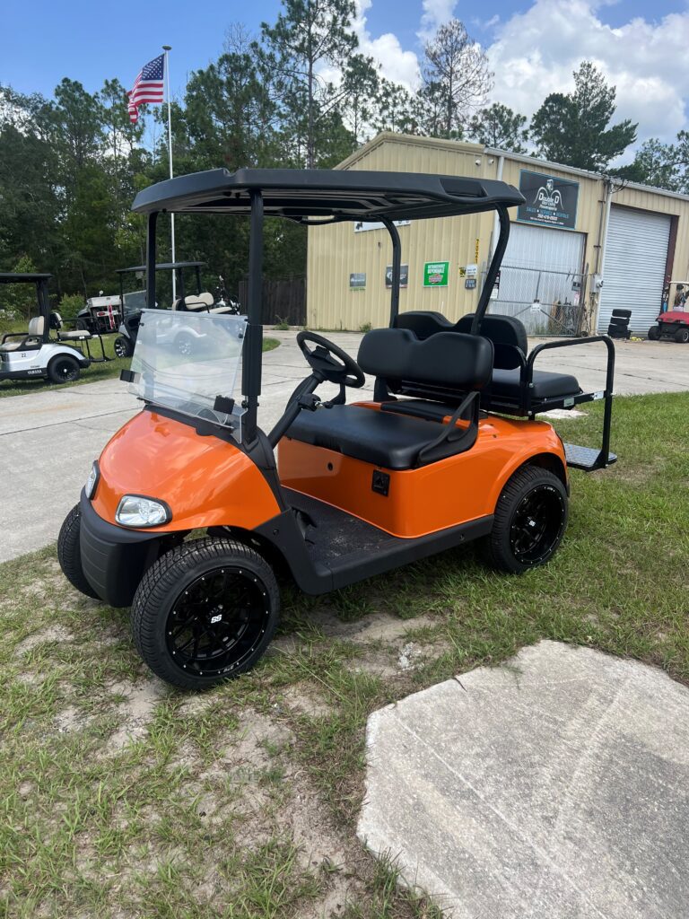2019 E-Z-GO RXV orange electric golf cart front three-quarter view